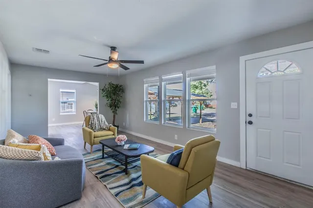 a living room with furniture and a large window