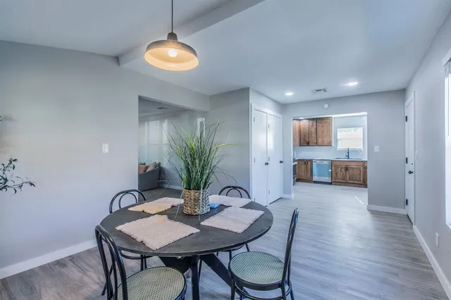 a view of a dining room with furniture and wooden floor