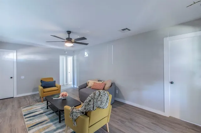 a living room with furniture and wooden floor