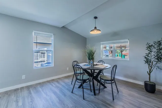 a view of a dining room with furniture wooden floor and chandelier