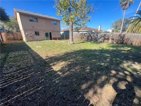 a view of a house with backyard and sitting area