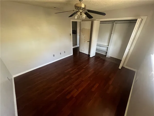 en empty room with wooden floor and window
