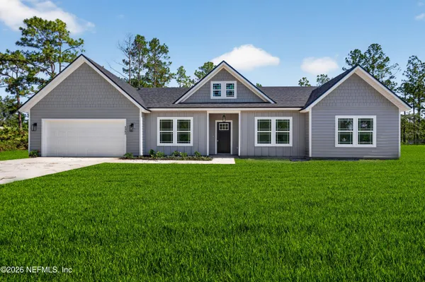 a front view of house with yard and green space