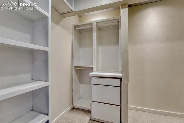 a view of a room with wooden floor and window