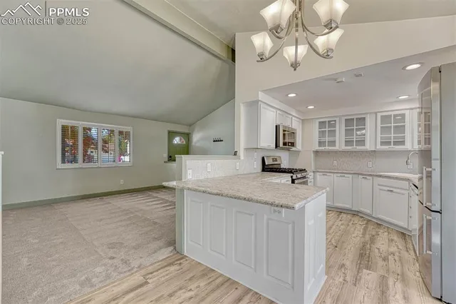 a kitchen with a stove kitchen island and stainless steel appliances