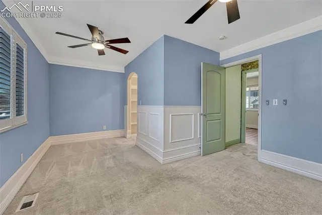 an empty room with closet and windows