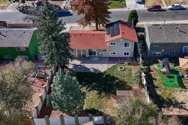 an aerial view of residential houses with outdoor space