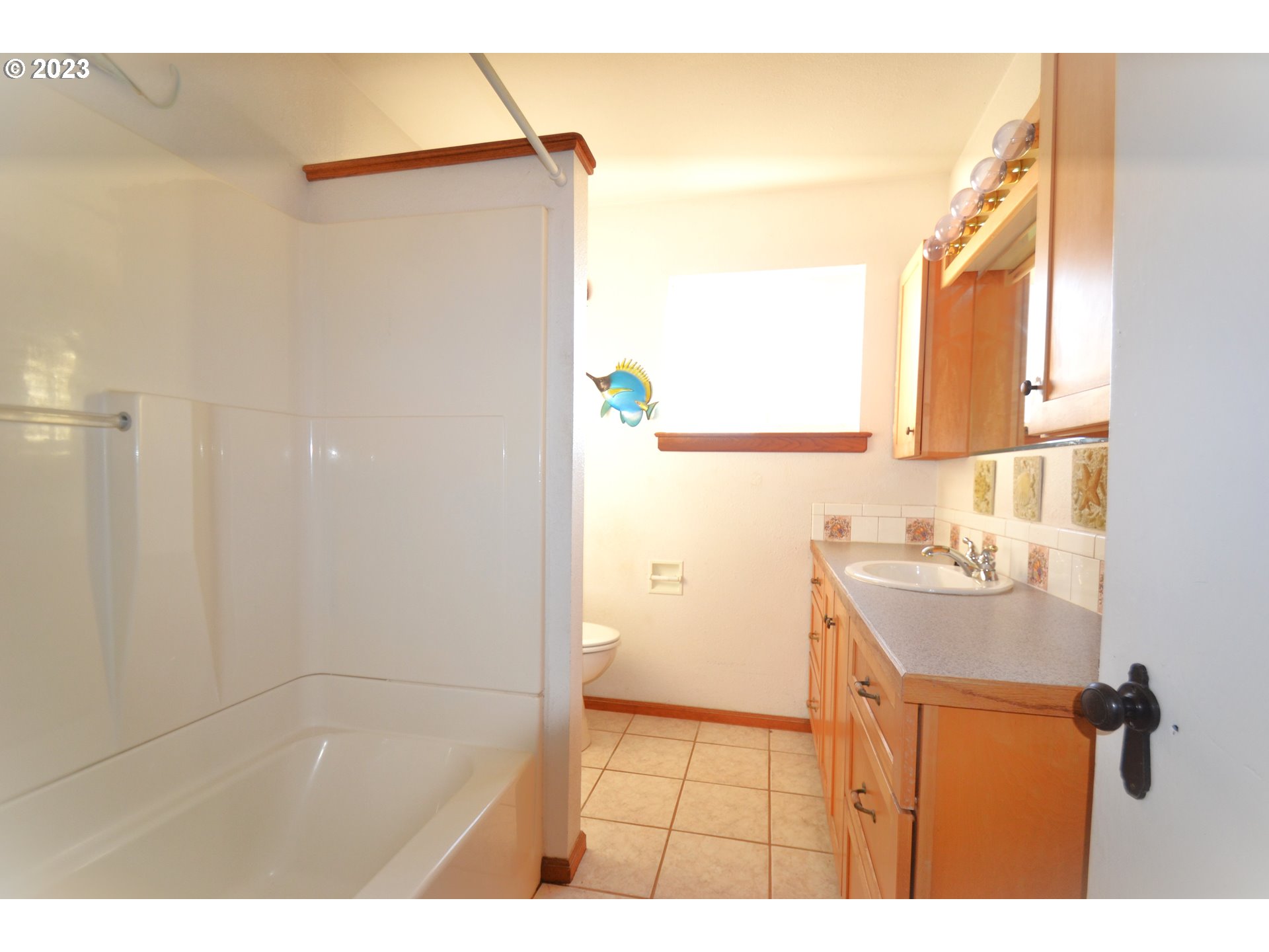 1985 Roseburg Road Myrtle Point, OR 97458 - Photo 14 of 29 a bathroom with a sink a mirror and a shower