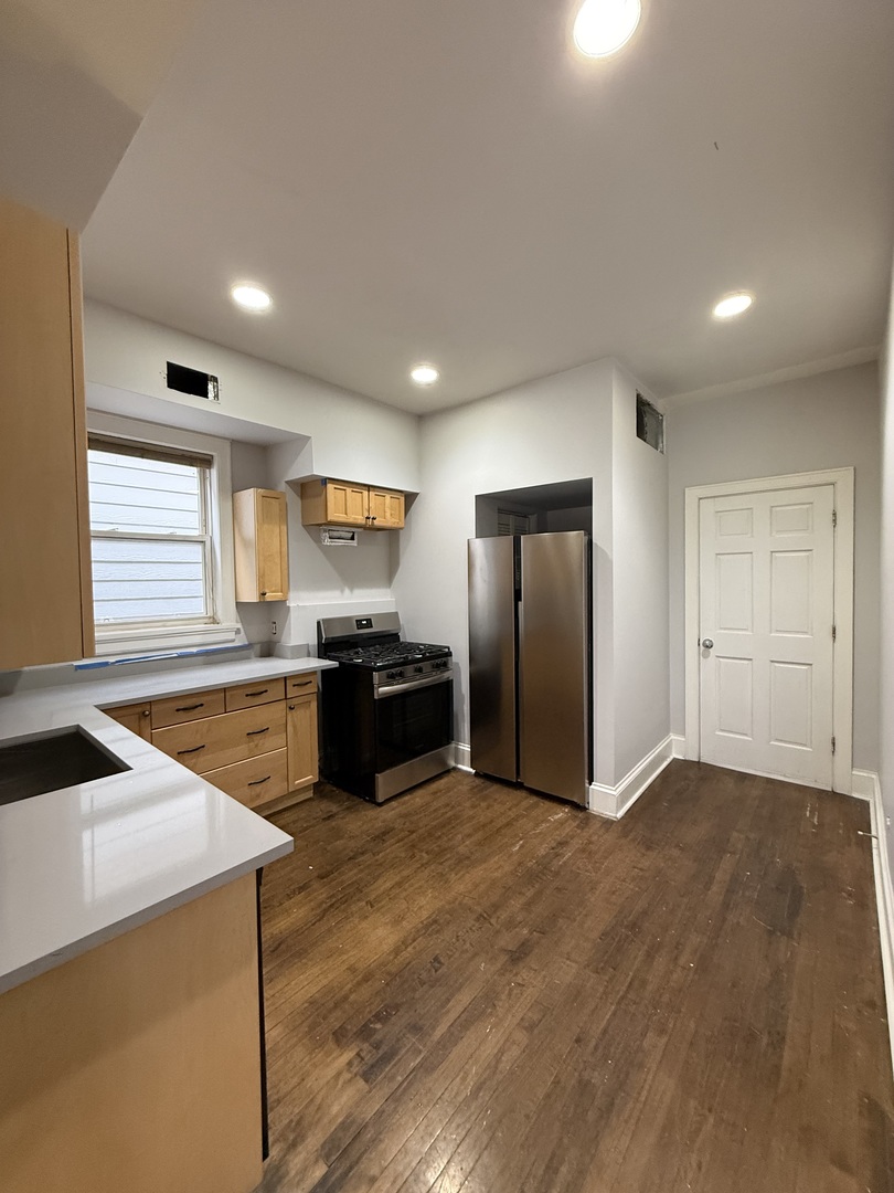 3252 West Crystal Street, Unit 2 Chicago, IL 60651 - Photo 5 of 13 a kitchen with stainless steel appliances a refrigerator and a sink