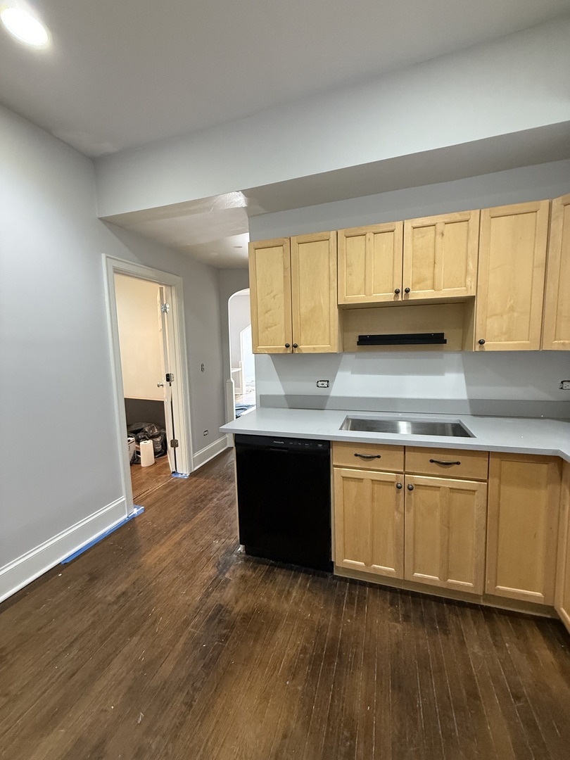 3252 West Crystal Street, Unit 2 Chicago, IL 60651 - Photo 7 of 13 a kitchen with granite countertop wooden floors and wide window