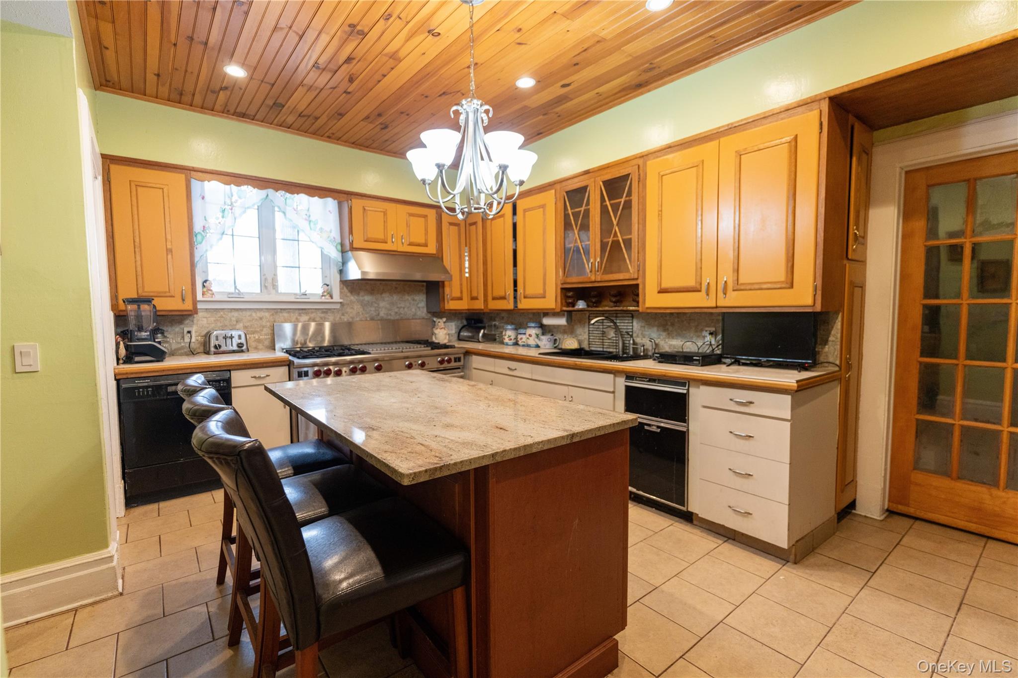 26 Overlook Circle New Rochelle, NY 10804 - Photo 5 of 15 a kitchen with a stove a sink a dining table and chairs