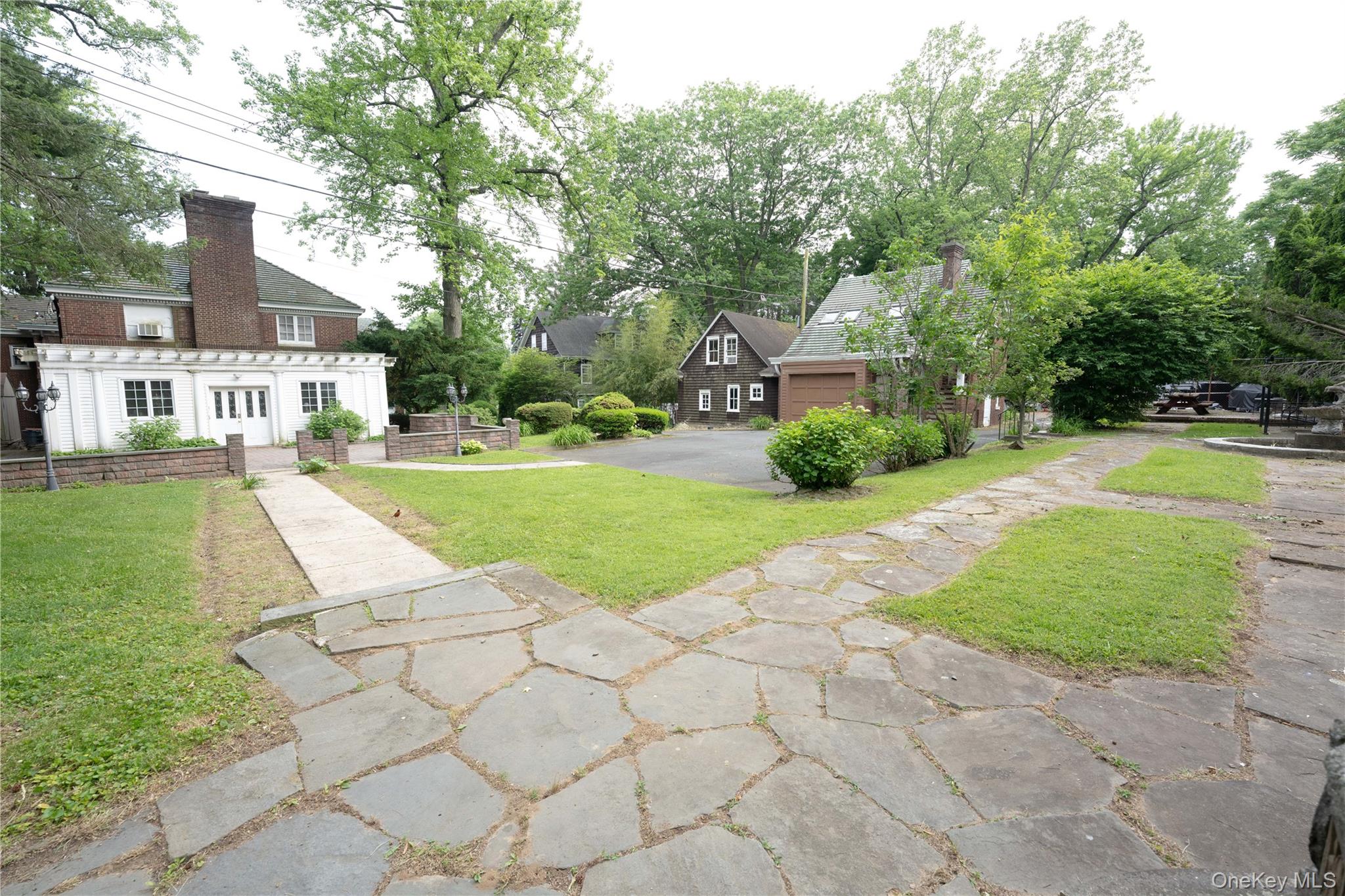 26 Overlook Circle New Rochelle, NY 10804 - Photo 10 of 15 a front view of a house with a yard and trees