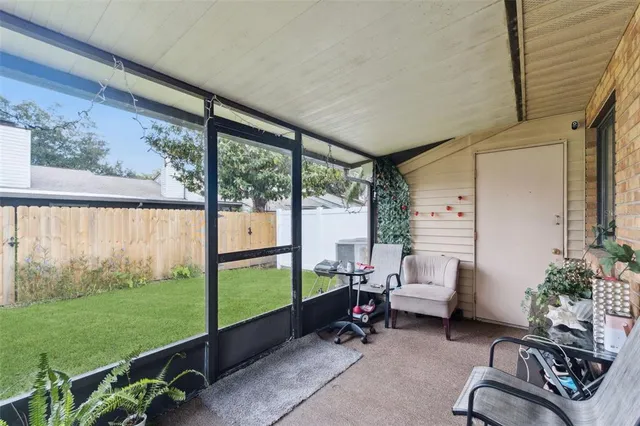 a living room with patio furniture and garden