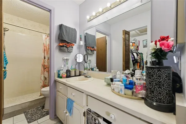 a bathroom with a sink mirror and vanity