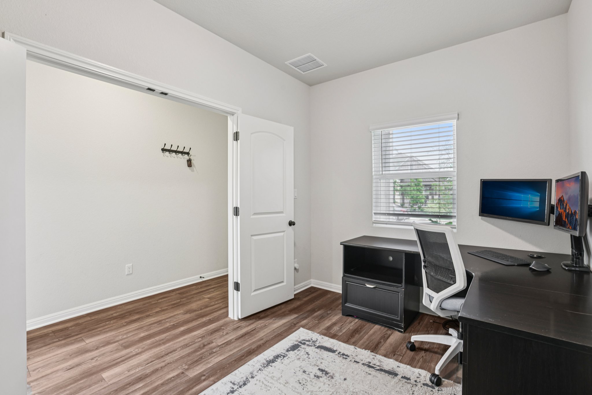 204 Swinging H Lane Georgetown, TX 78633 - Photo 10 of 39 This room features wood-look flooring, a window with blinds, and white walls