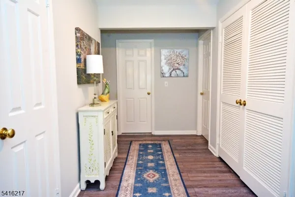 a view of hallway with wooden floor