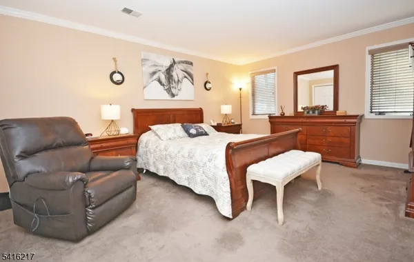 a bedroom with a bed and a couch