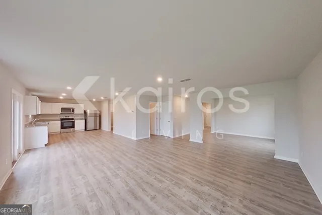 a view of a room with wooden floor