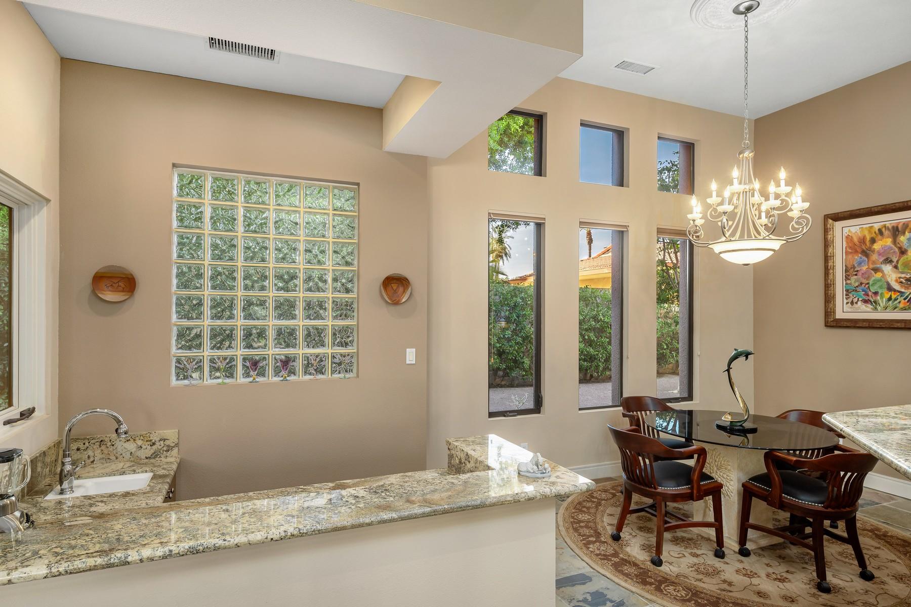 12 Dominion Court Rancho Mirage, CA 92270 - Photo 11 of 44 a dining room with wooden floor and a chandelier