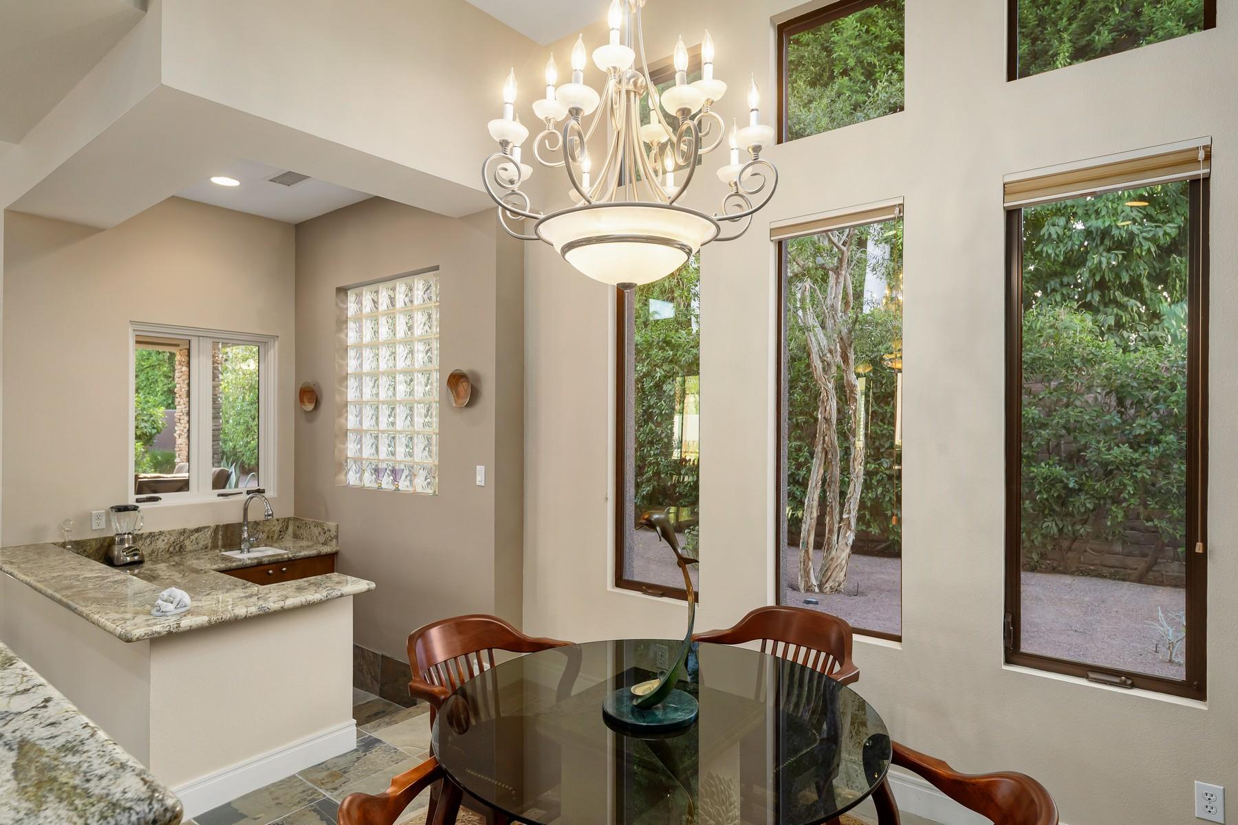 12 Dominion Court Rancho Mirage, CA 92270 - Photo 12 of 44 a view of a dining room with furniture a chandelier and large windows