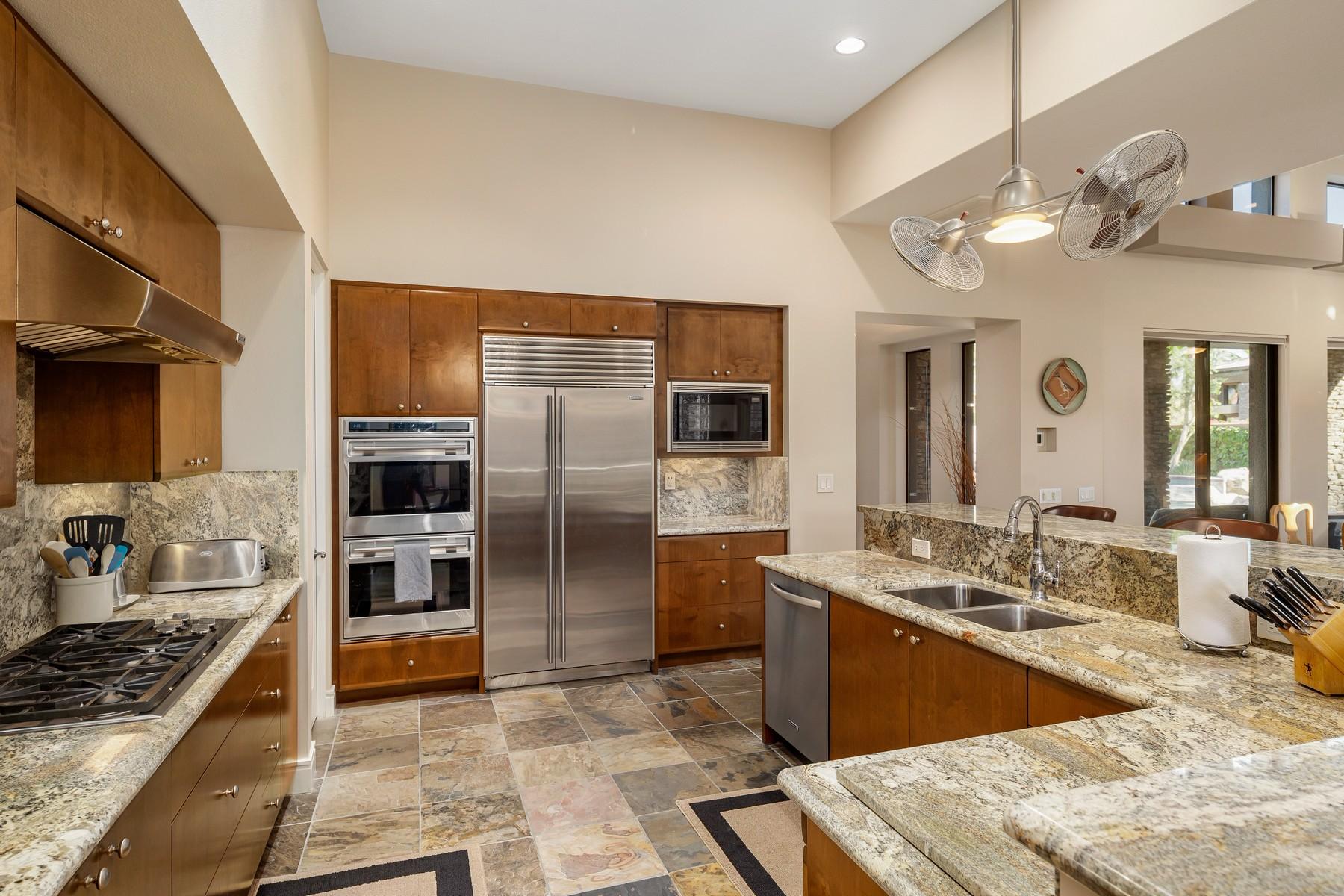 12 Dominion Court Rancho Mirage, CA 92270 - Photo 13 of 44 a kitchen with stainless steel appliances kitchen island granite countertop a stove refrigerator and cabinets