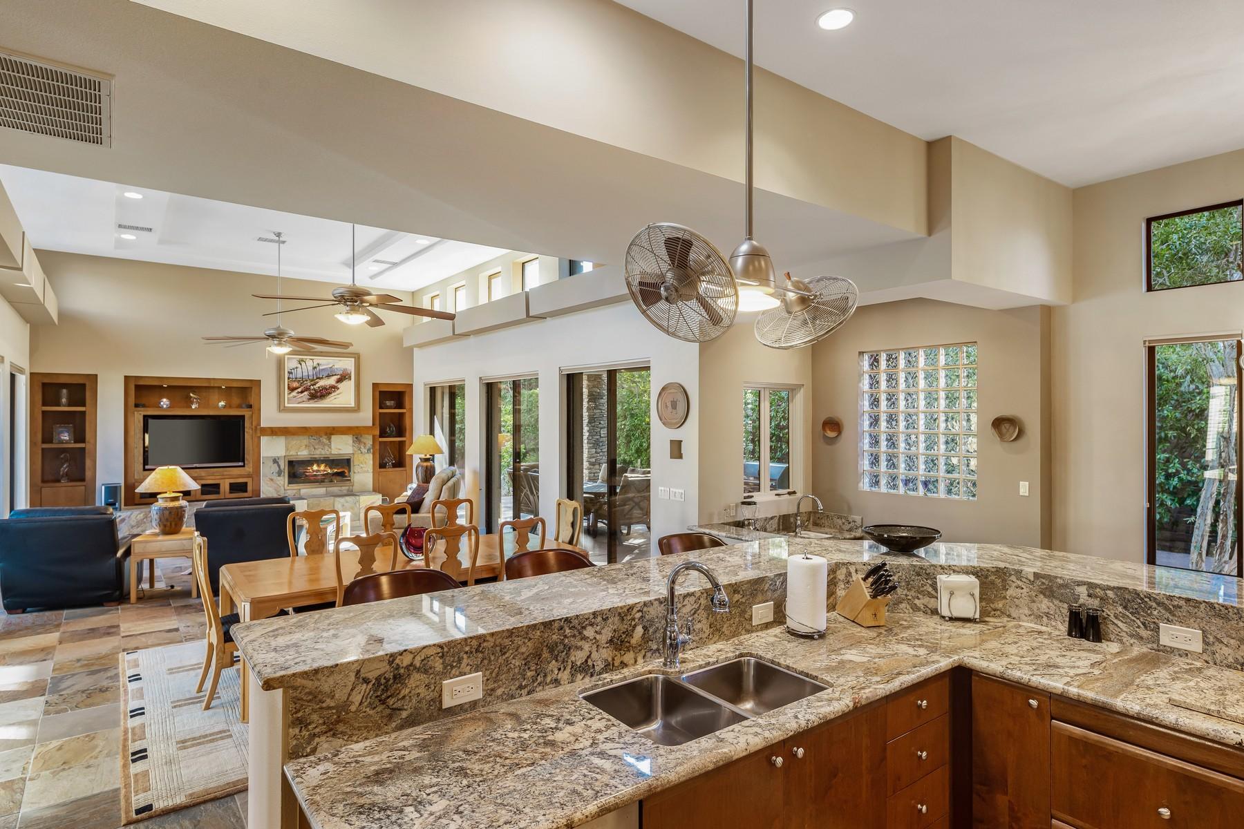 12 Dominion Court Rancho Mirage, CA 92270 - Photo 14 of 44 a view of a kitchen with kitchen island granite countertop a large window cabinets a sink and stainless steel appliances