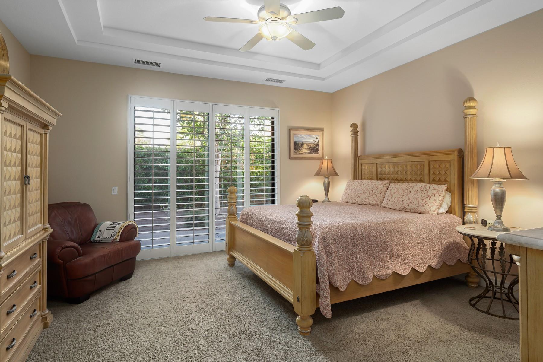 12 Dominion Court Rancho Mirage, CA 92270 - Photo 19 of 44 a spacious bedroom with a bed and a couch