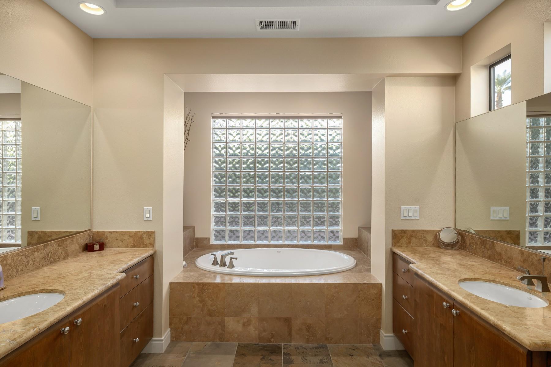 12 Dominion Court Rancho Mirage, CA 92270 - Photo 20 of 44 a bathroom with a granite countertop tub sink and mirror