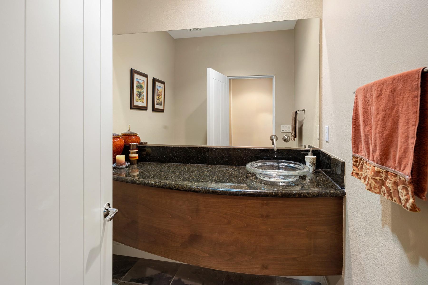 12 Dominion Court Rancho Mirage, CA 92270 - Photo 28 of 44 a bathroom with a granite countertop sink a mirror and shower