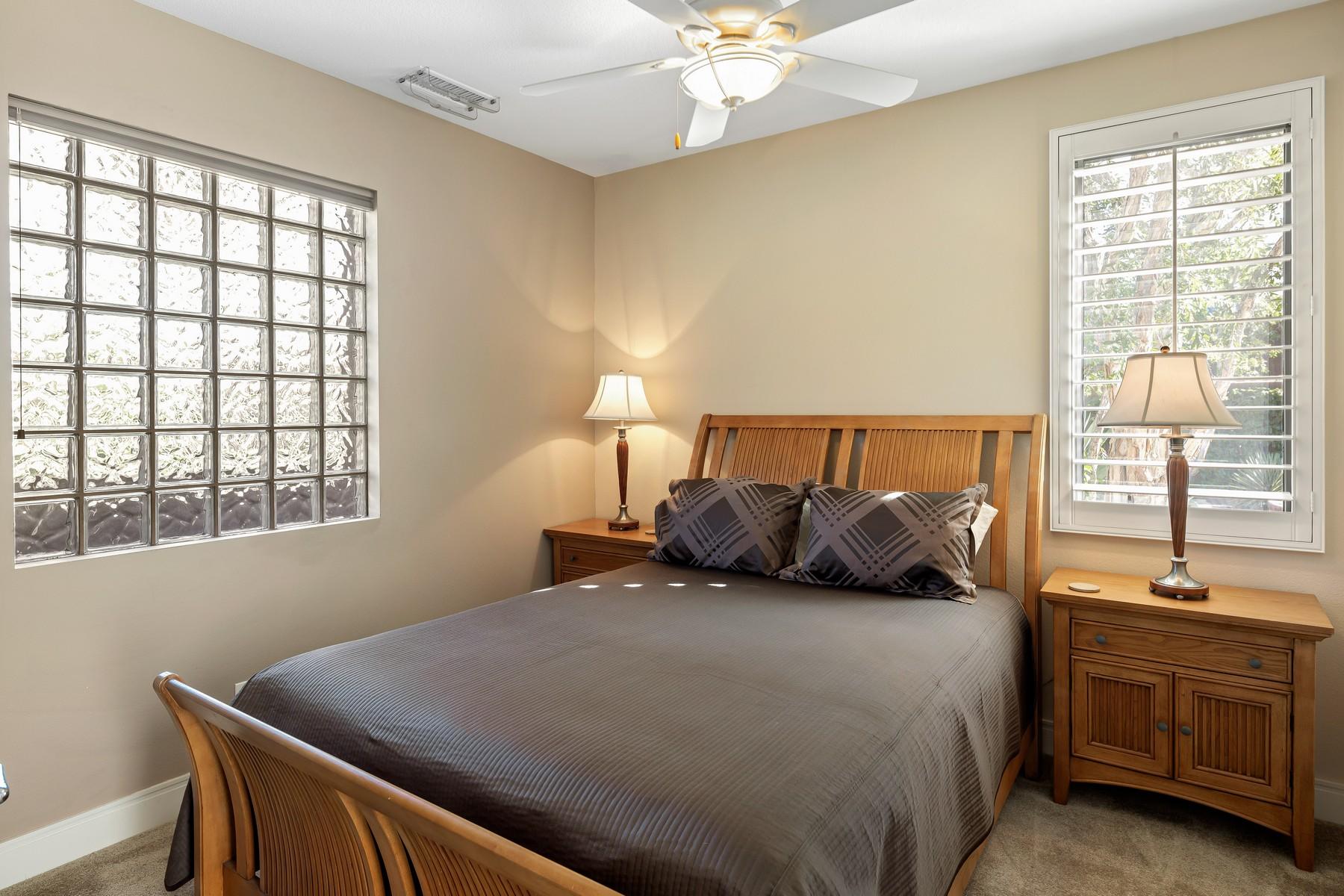 12 Dominion Court Rancho Mirage, CA 92270 - Photo 30 of 44 a bedroom with a large bed and a window