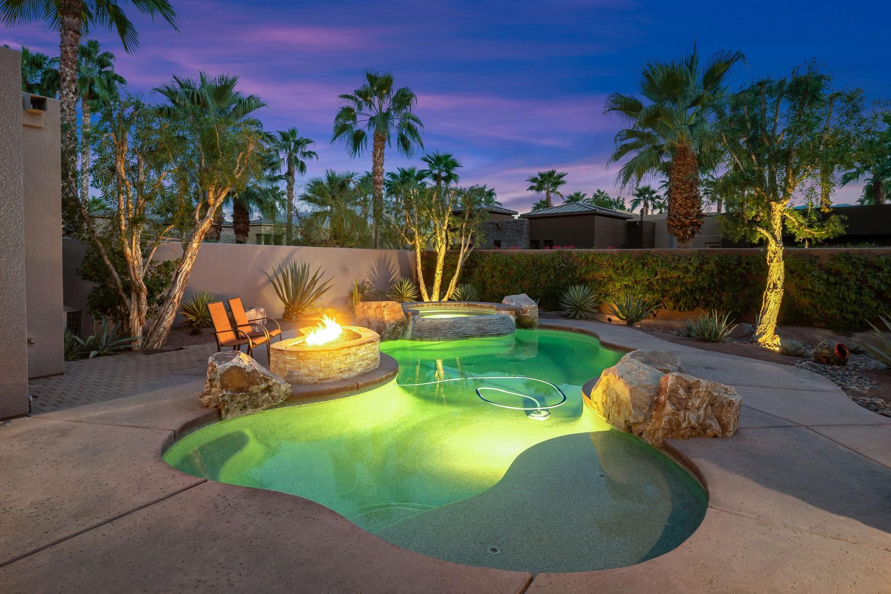 12 Dominion Court Rancho Mirage, CA 92270 - Photo 40 of 44 a view of a swimming pool with a chairs and table in the patio