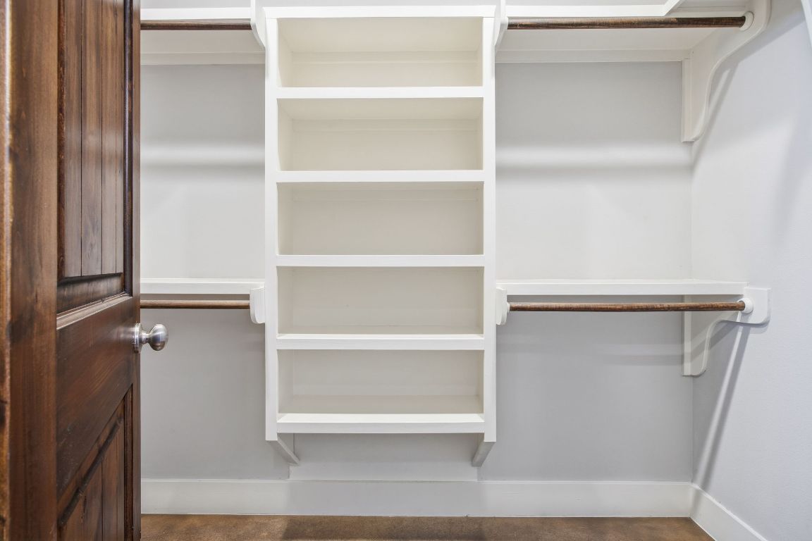 1125 Walton Lane, Unit D Austin, TX 78721 - Photo 20 of 34 a view of walk in closet with empty racks