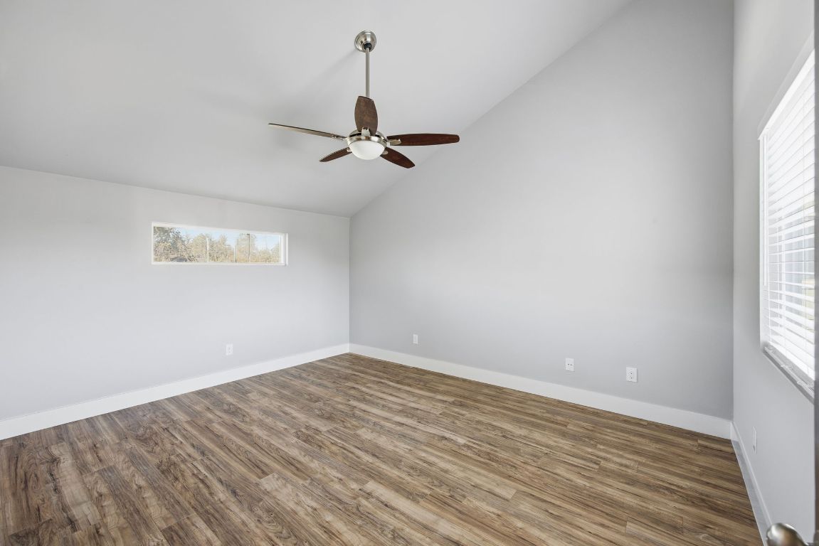 1125 Walton Lane, Unit D Austin, TX 78721 - Photo 22 of 34 a view of a room with a window and a ceiling fan
