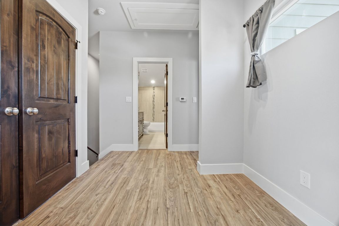 1125 Walton Lane, Unit D Austin, TX 78721 - Photo 25 of 34 a view of a room with wooden floor and a bathroom