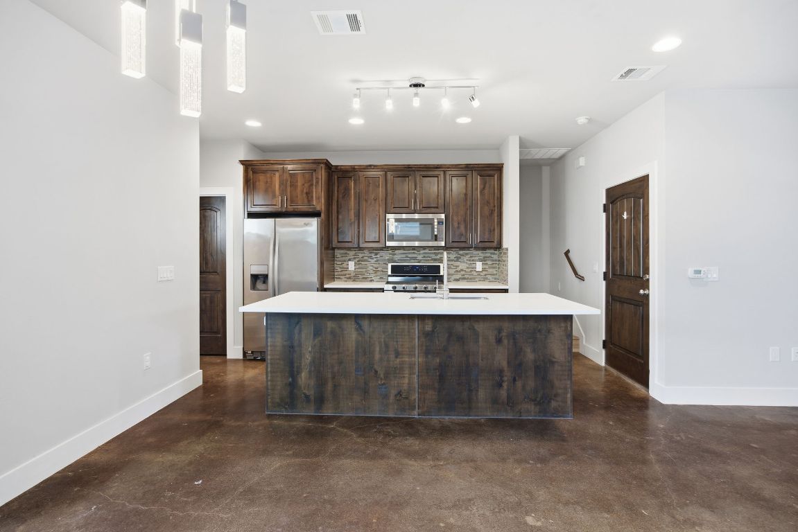 1125 Walton Lane, Unit D Austin, TX 78721 - Photo 5 of 34 a kitchen with stainless steel appliances a sink stove and refrigerator