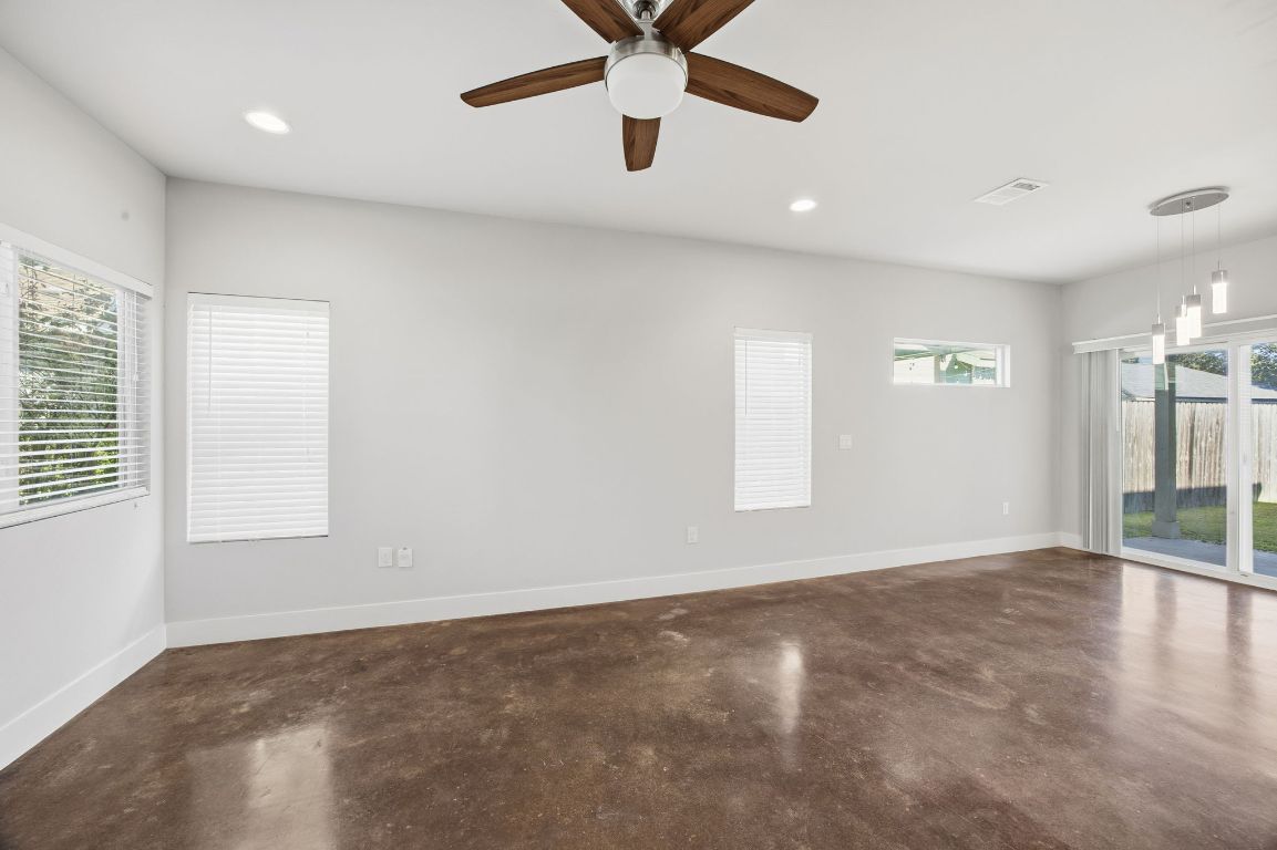 1125 Walton Lane, Unit D Austin, TX 78721 - Photo 6 of 34 wooden floor in an empty room with a window