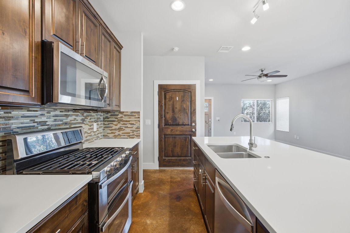 1125 Walton Lane, Unit D Austin, TX 78721 - Photo 10 of 34 a kitchen with refrigerator and cabinets