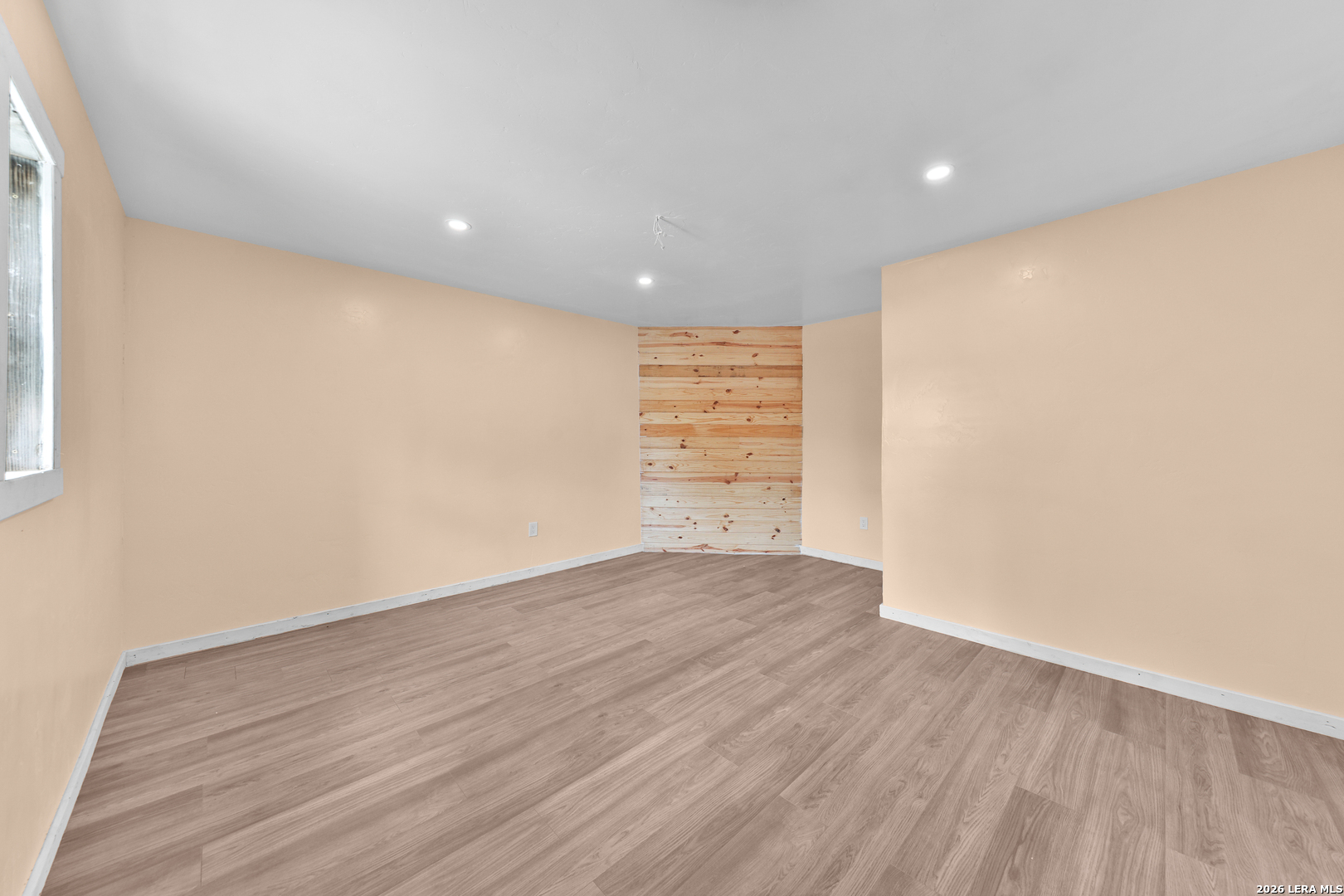 122 Brink Center Point, TX 78010 - Photo 29 of 40 a view of an empty room with wooden floor and a window