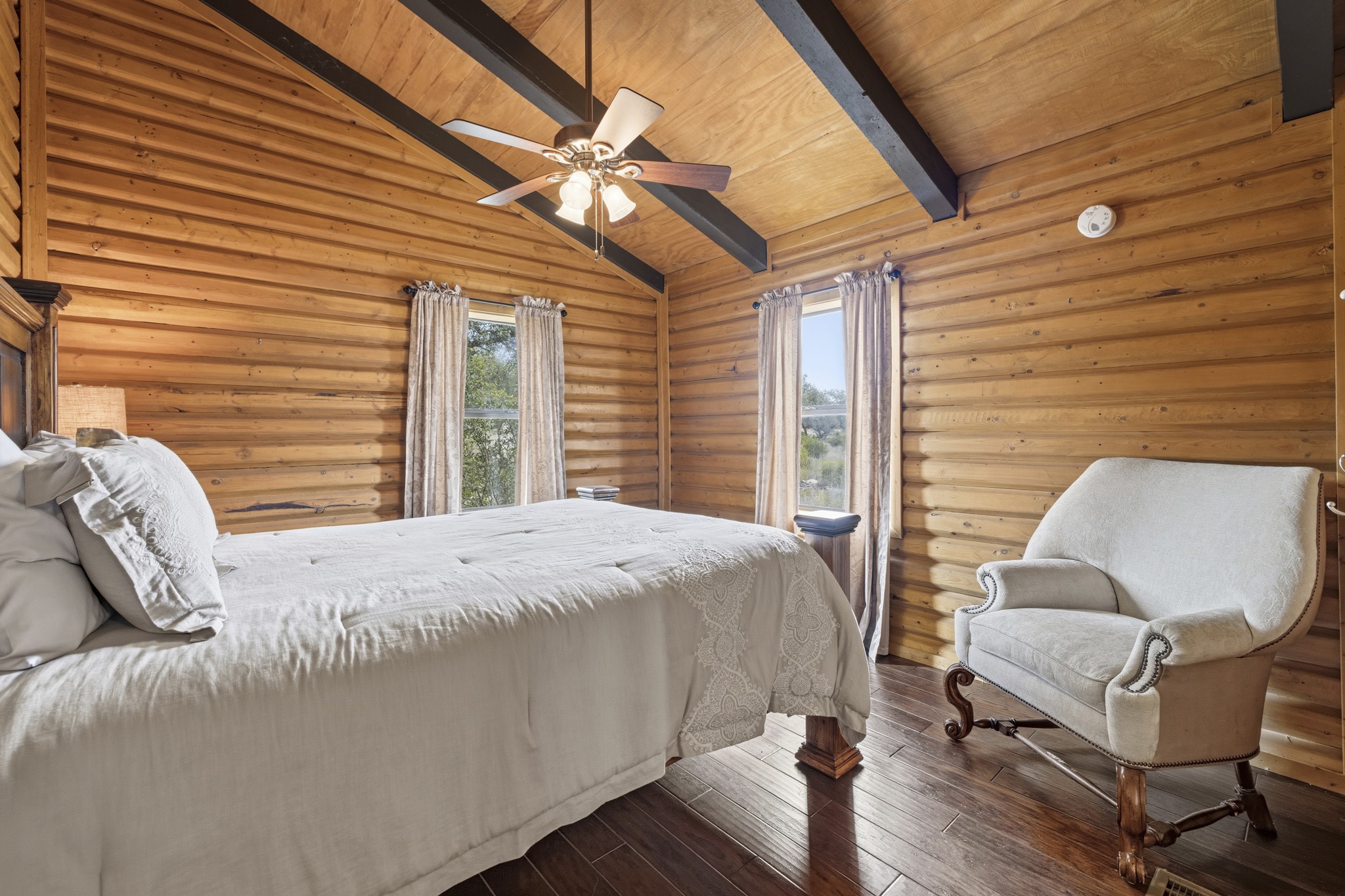 611 Weddle Road Johnson City, TX 78636 - Photo 18 of 30 a bedroom with a bed wooden floor and window
