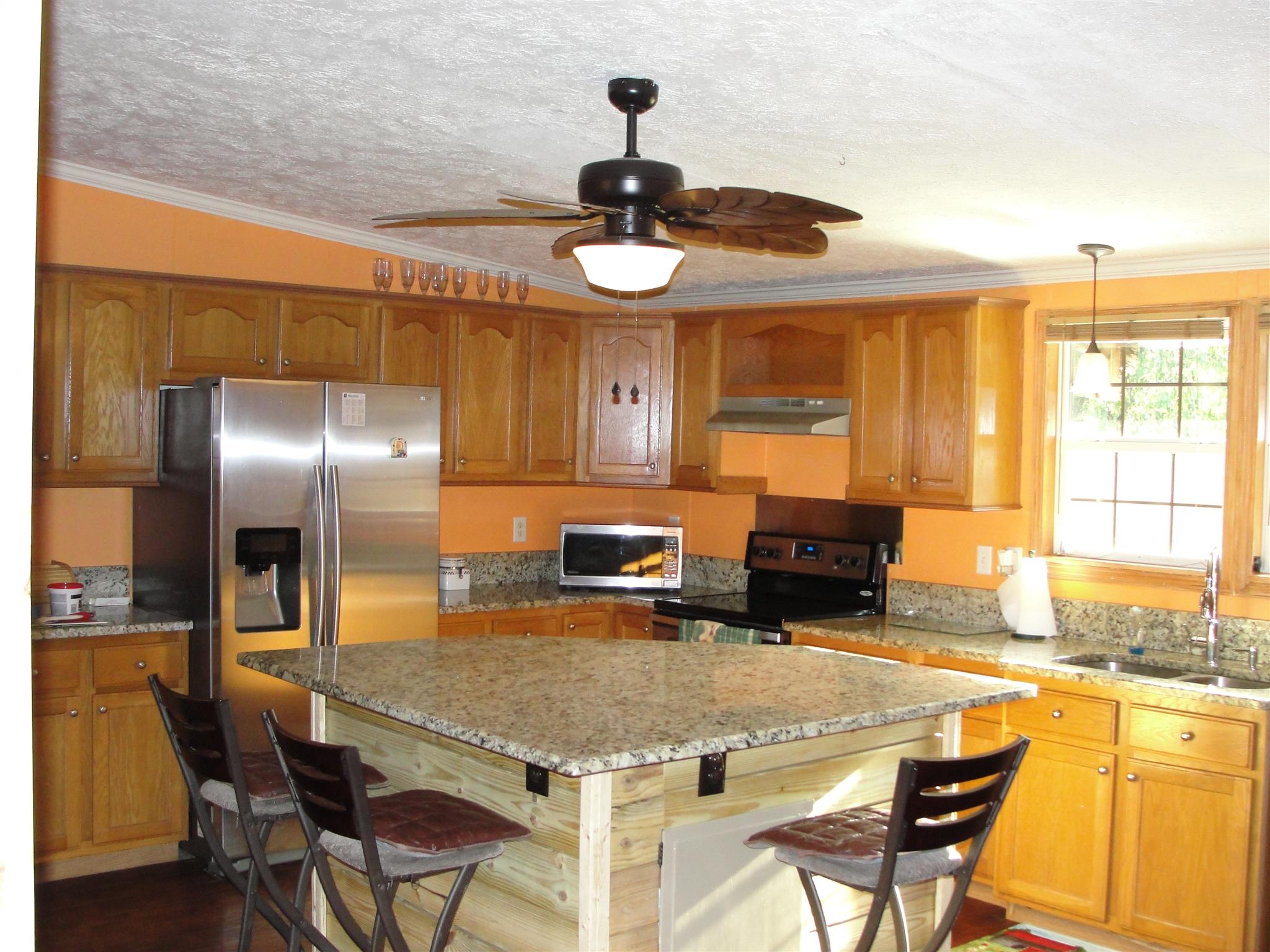 10026 Judy Road Lyles, TN 37098 - Photo 1 of 20 a kitchen with stainless steel appliances granite countertop a sink and a refrigerator