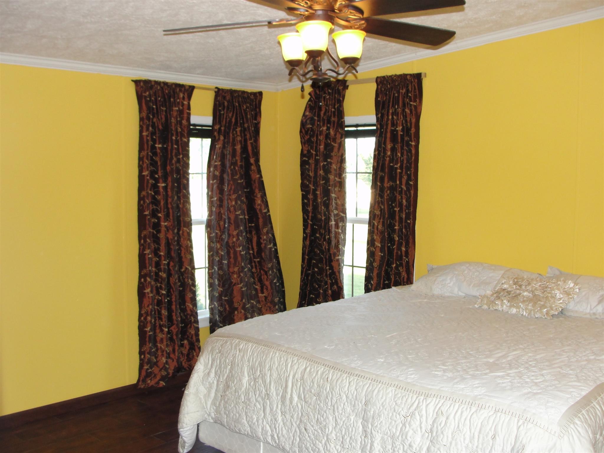 10026 Judy Road Lyles, TN 37098 - Photo 11 of 20 a bedroom with a bed and a chandelier