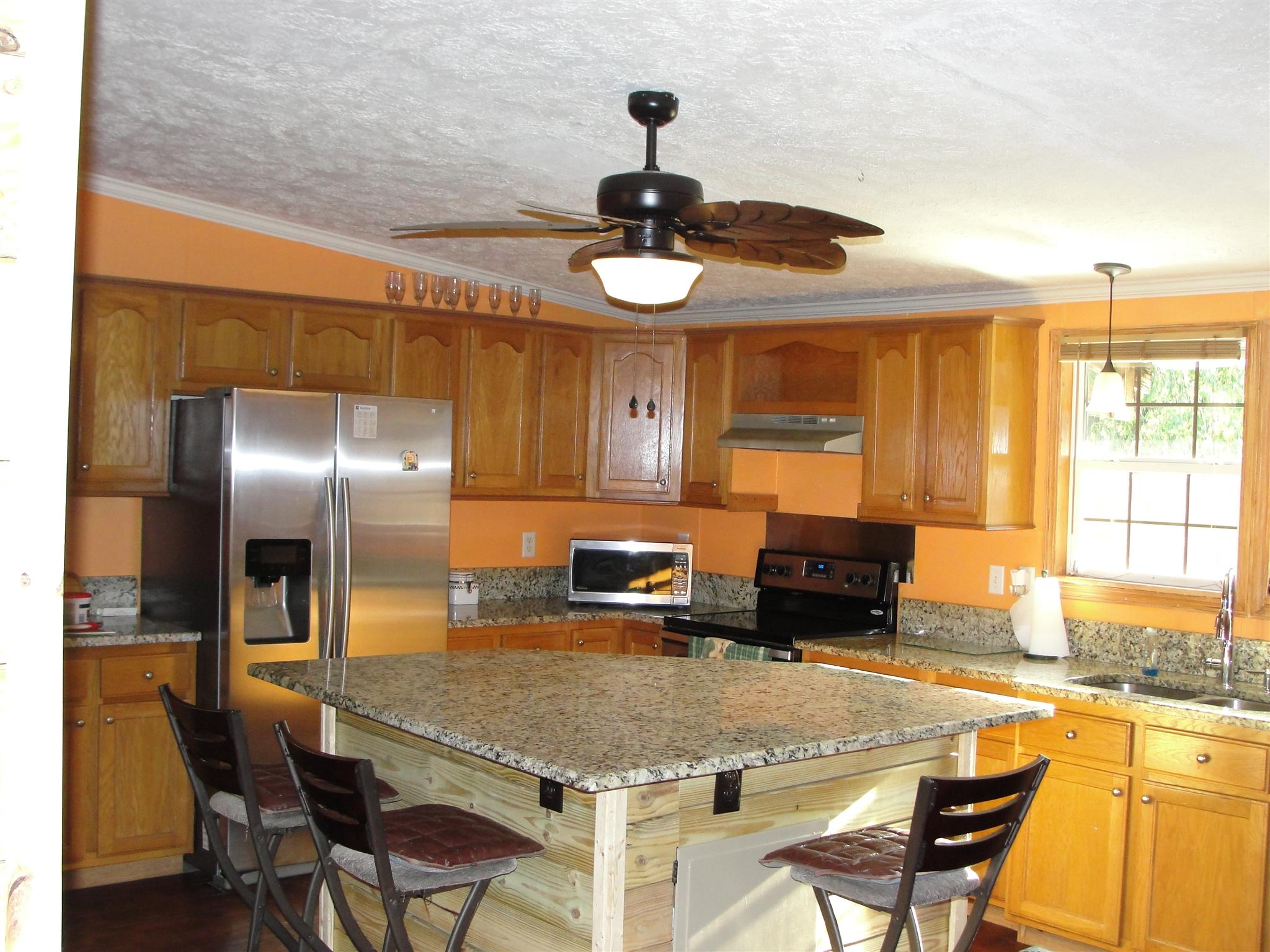 10026 Judy Road Lyles, TN 37098 - Photo 3 of 20 a kitchen with stainless steel appliances granite countertop a sink and a refrigerator
