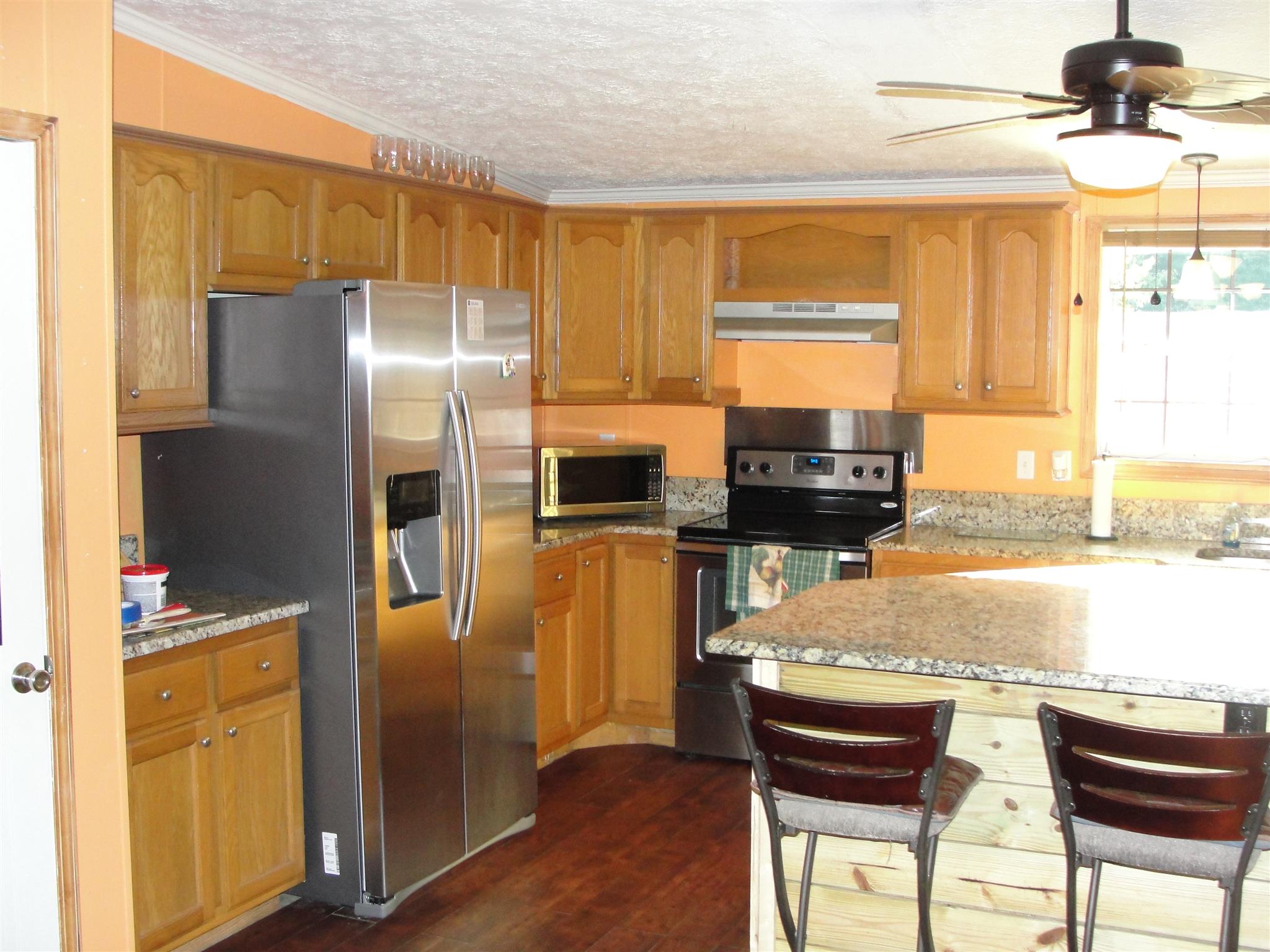 10026 Judy Road Lyles, TN 37098 - Photo 4 of 20 a kitchen with stainless steel appliances granite countertop a refrigerator and a stove top oven