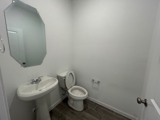 26711 Grandiflora Drive Magnolia, TX 77355 - Photo 7 of 19 a bathroom with a toilet sink and mirror