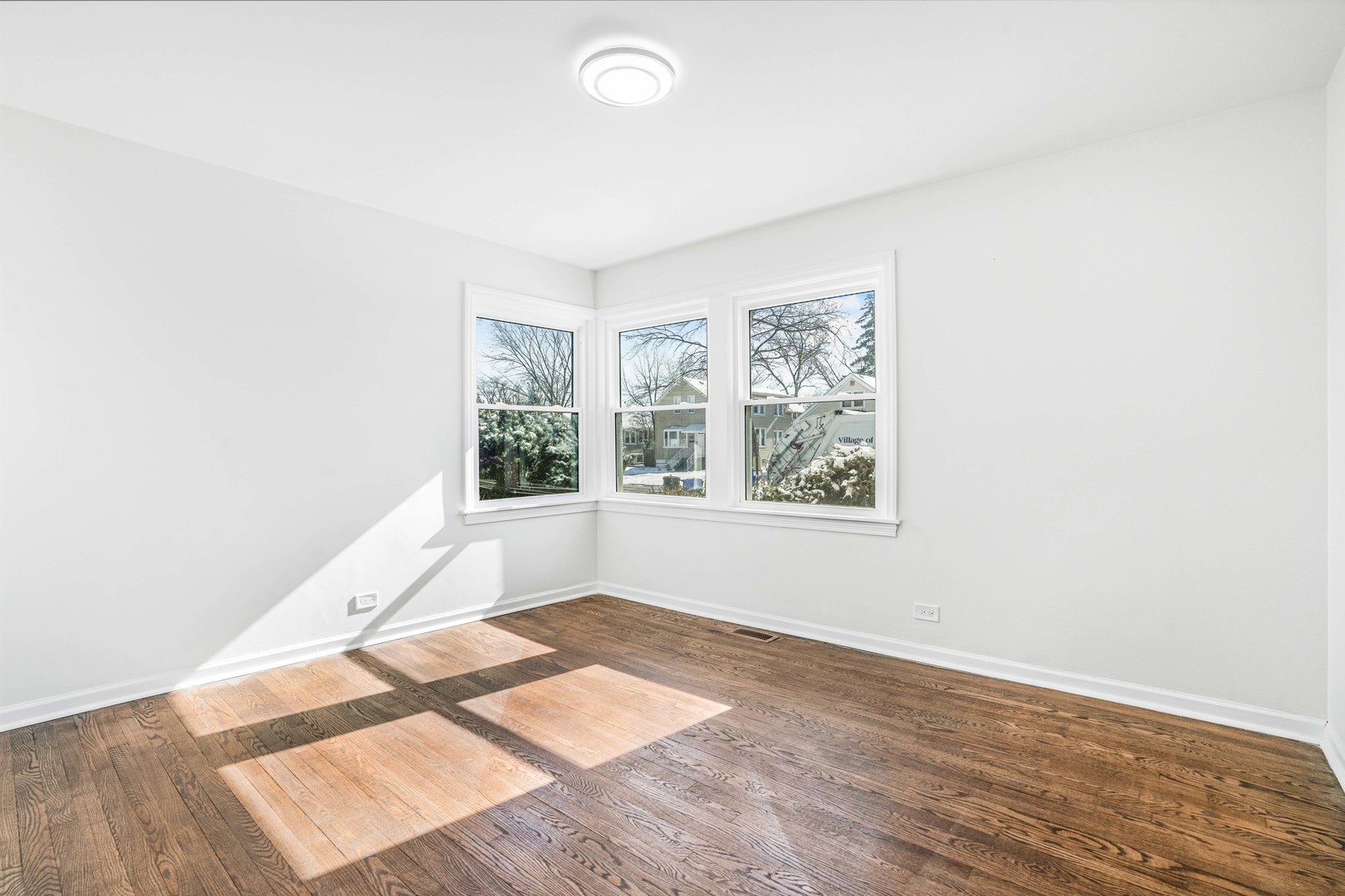 8110 46th Street Lyons, IL 60534 - Photo 15 of 26 an empty room with wooden floor and windows