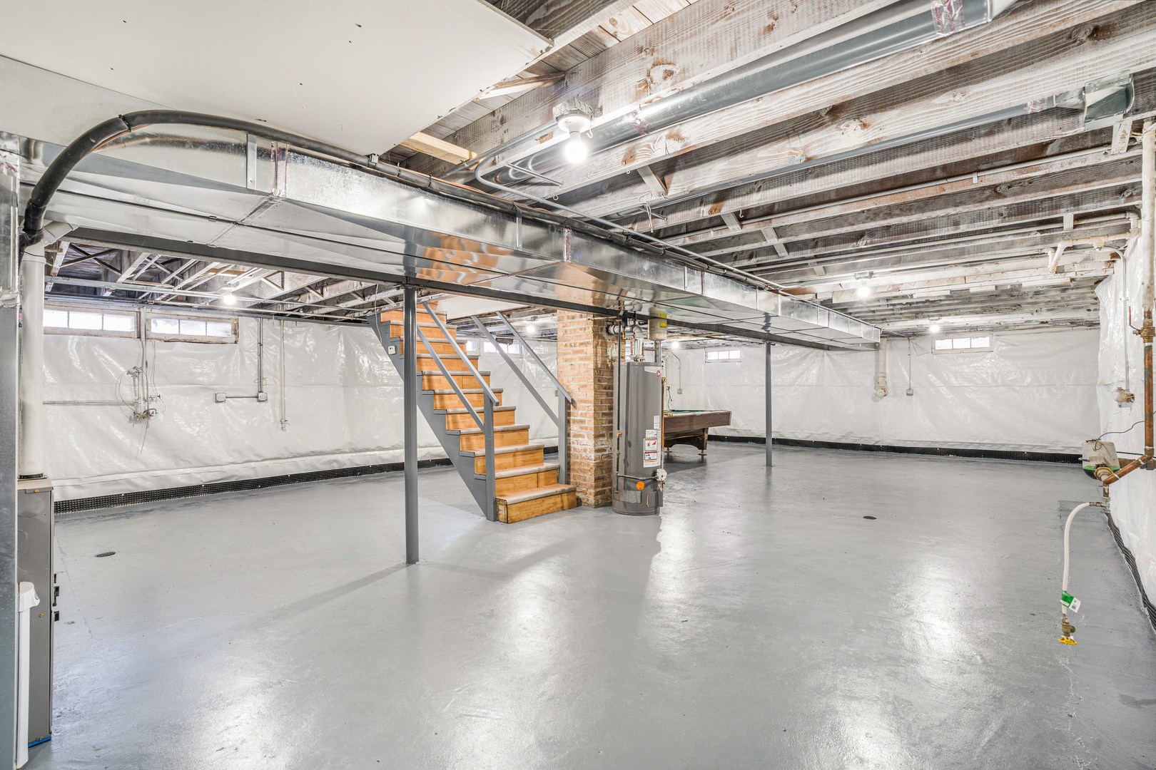 8110 46th Street Lyons, IL 60534 - Photo 17 of 26 a view of a water heater room with wooden walls