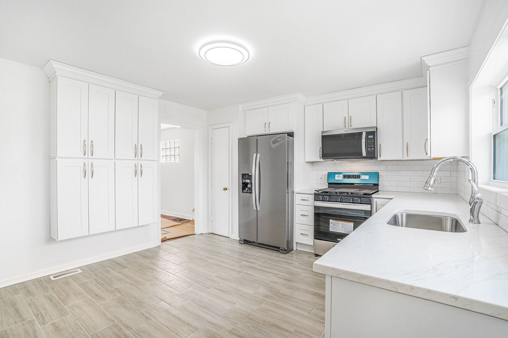 8110 46th Street Lyons, IL 60534 - Photo 6 of 26 a kitchen with a refrigerator stove and sink