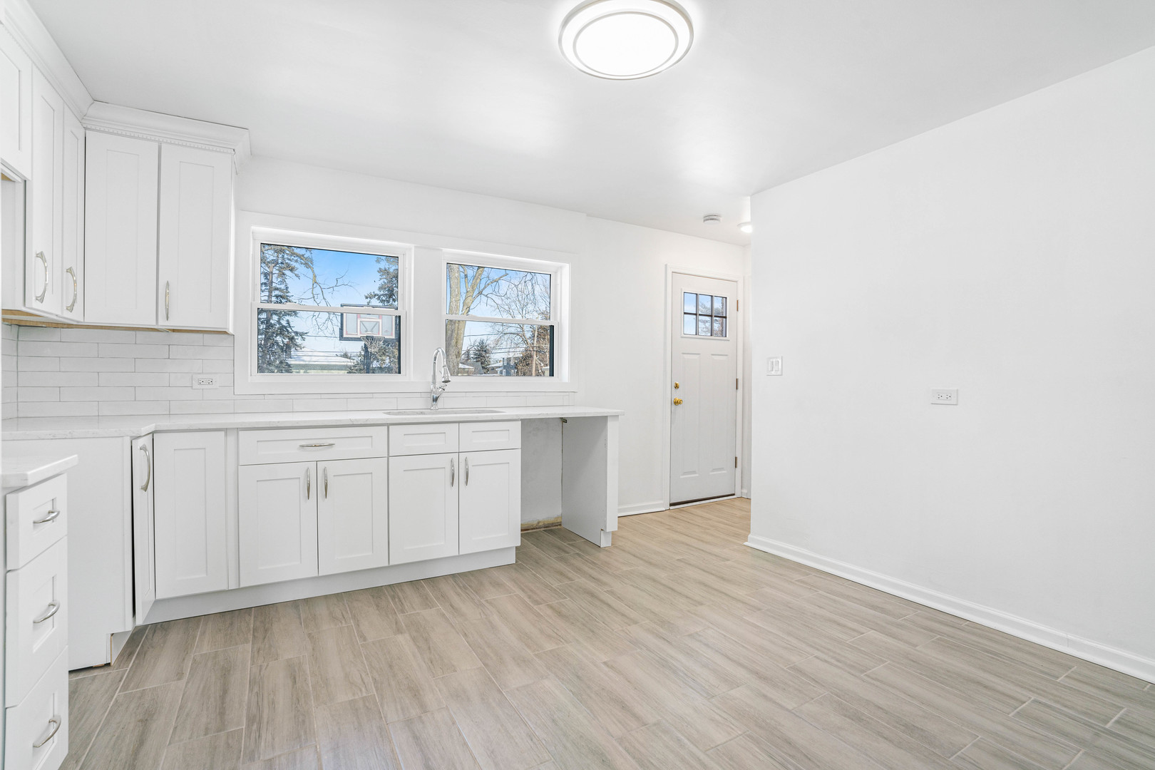 8110 46th Street Lyons, IL 60534 - Photo 7 of 26 a room with a white cabinets and wooden floor
