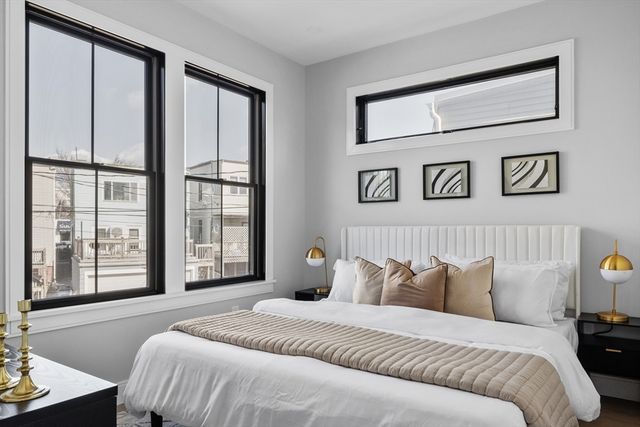 a bedroom with a large bed and a window