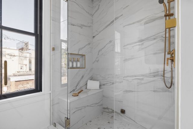 a bathroom with a glass shower door